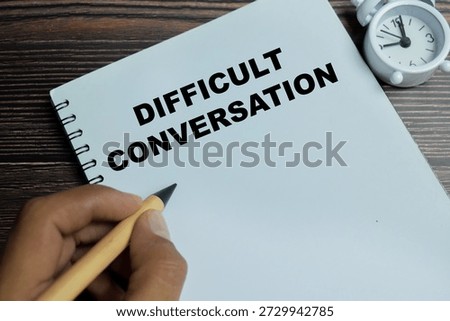 Concept of difficult conversation write on book isolated on Wooden Table.