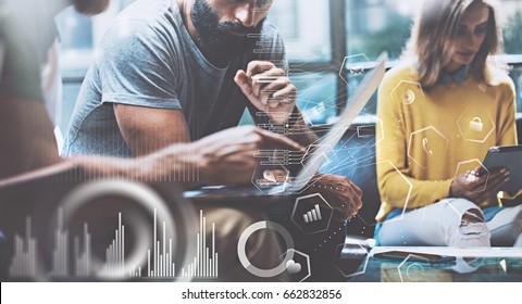 Concept of digital diagram,graph interfaces,virtual screen,connections icon.Young entrepreneurs people working at modern office.Man using contemporary laptop,blurred background.Horizontal