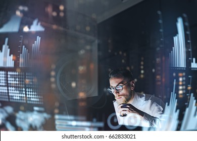 Concept of digital diagram,graph interfaces,virtual screen,connections icon.Young finance analist working at modern office.Man using contemporary laptop at night,blurred background.Horizontal - Shutterstock ID 662833021
