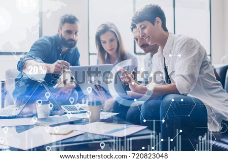 Concept of digital diagram,graph interfaces,virtual screen,connections icon on blurred background.Coworking team at business meeting.Group of colleagues working with startup project in modern office