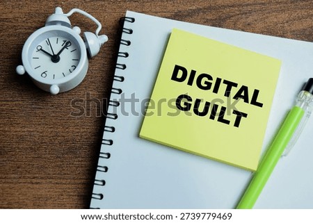 Concept of digital guilt write on sticky notes isolated on Wooden Table.