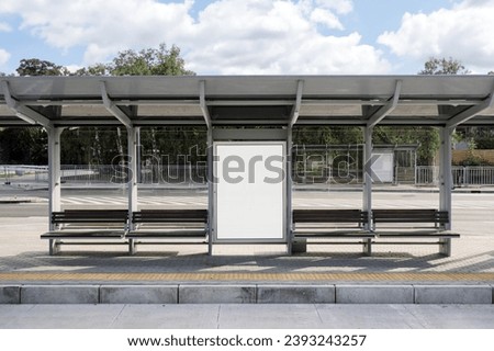 Concept of digital marketing in the city. Advertising billboard with white empty canvas on bus shelters with protective glass. Citylight on public transport stop