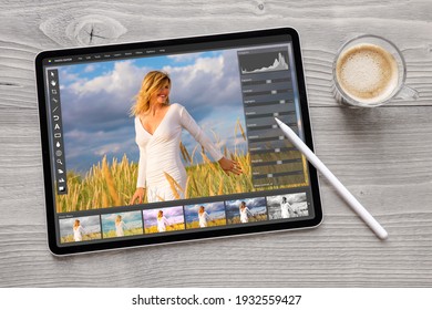 Concept of digital photo editing on tablet computer with wireless stylus pen