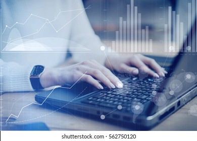 Concept of digital screen,virtual connection icon,diagram,graph interfaces.Closeup view young businesswoman working at a laptop, typing on keyboard while sitting her work place.Blurred effect - Shutterstock ID 562750120