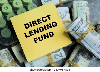 Concept of direct lending fund write on sticky notes isolated on Wooden Table. For private credit investment strategy and corporate debt managements