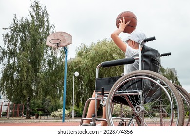 Concept Of Disabled Child, Support, Rehabilitation, Disabled Person, Paralyzed, Happy Disabled Child. Disabled Boy At School On The Sports Ground