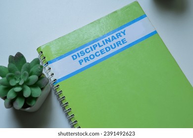 Concept of Disciplinary Procedure write on book isolated on Wooden Table.