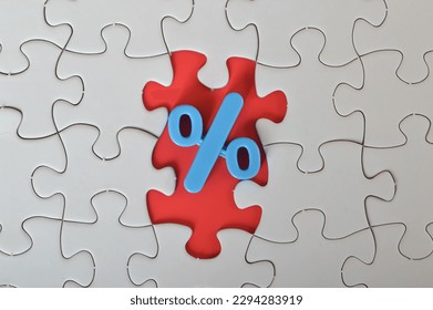 The concept of discounted selling and a big sale are conveyed through a missing jigsaw puzzle that features a percentage symbol.