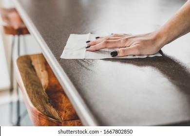 concept of disinfecting surfaces from bacteria or viruses, hand cleaning bar table with disinfectant wet wipe  - Shutterstock ID 1667802850