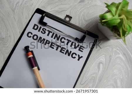 Concept of distinctive competency write on clipboard isolated on Wooden Table.