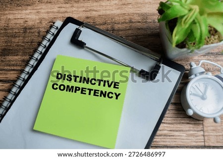 Concept of distinctive competency write on sticky notes isolated on Wooden Table.