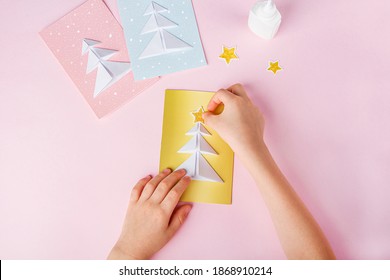 Concept Of DIY And Kid's Creativity, Origami. Step By Step Instruction: How To Make Greeting Cards With Christmas Trees Origami. Step6 Glue Star On Postcard. New Year Craft