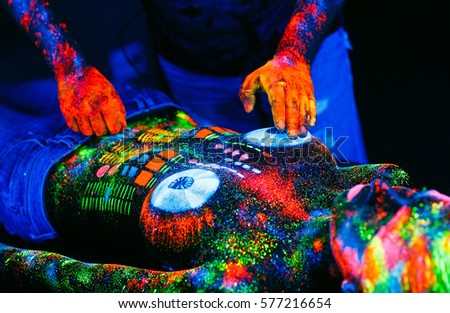 Concept. DJ playing on the deck. Girl painted as a DJ deck.