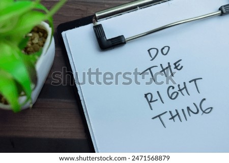 Concept of Do The Right Thing write on paperwork isolated on wooden background.