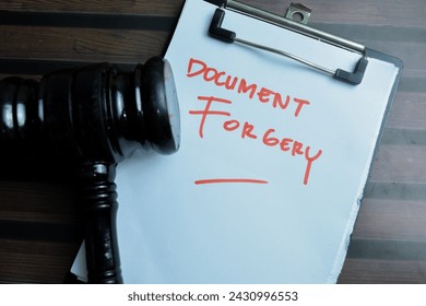 Concept of Document Forgery write on paperwork isolated on wooden background.