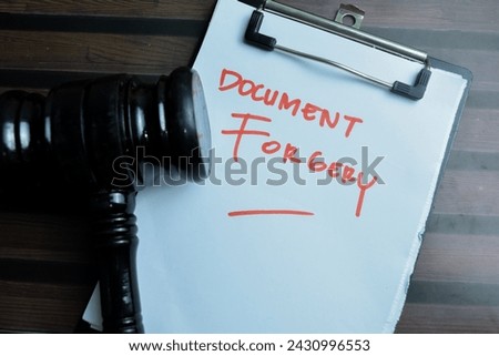 Concept of Document Forgery write on paperwork isolated on wooden background.