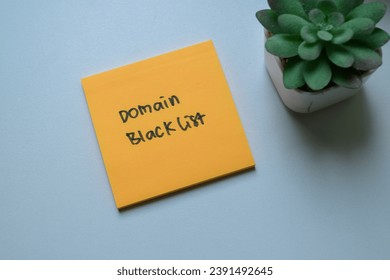 Concept of Domain Blacklist write on sticky notes isolated on Wooden Table.