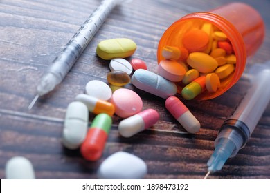 The Concept Of Drug Overdose, Syringe And Pills On Dark Background, Close Up 