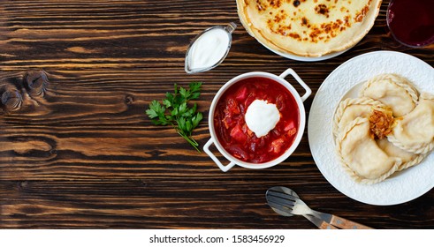 The Concept Of Eastern European National Cuisine. Ukrainian, Russian, Polish Food.Traditional Beetroot Soup Borscht With Sour Cream, Pancakes Blini, Dumplings Vareniki With Potatoes And Fried Onions