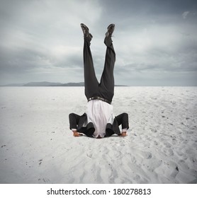Concept of economic downfall with businessman upside down