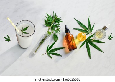 Concept Edibles CBD And Drinks With Cannabis . Glasses With Fresh Beverage, Milk And Smoothies, With Hemp. Flat Lay