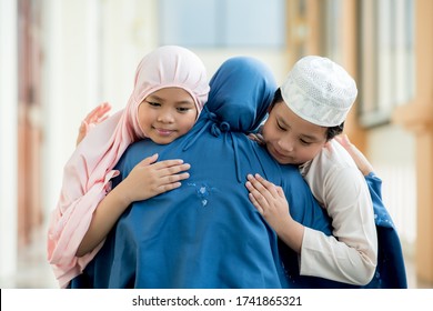 Concept Eid Mubarak, Muslim Girls And Boys Are Muslim, Hugging With Their Mother In Love At The Mosque After Prayer.