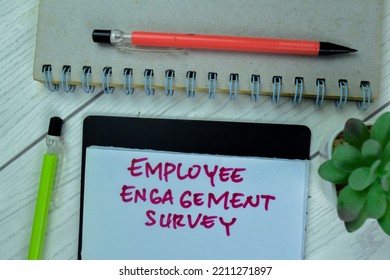 Concept Of Employee Engagement Survey Write On Sticky Notes Isolated On Wooden Table.