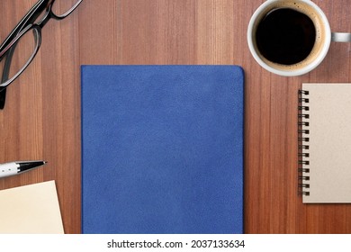 Concept Of Employee Handbook Over Wooden Office Table.