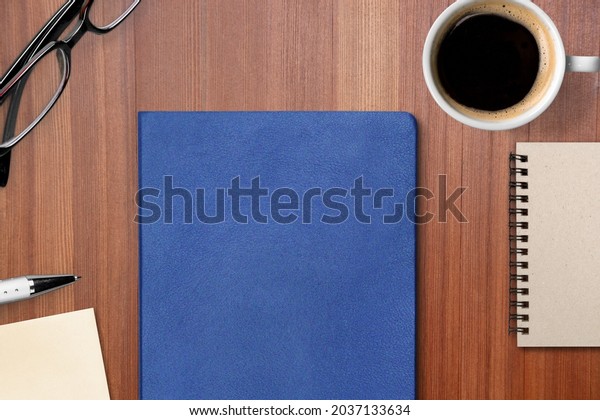 Concept of\
employee handbook over wooden office\
table.