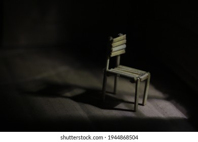 The Concept Of An Empty Wooden Chair In The Moonlight Outside The Window.