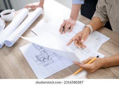 Concept of engineering consulting, Two female engineers is checking blueprint of building together. - Powered by Shutterstock