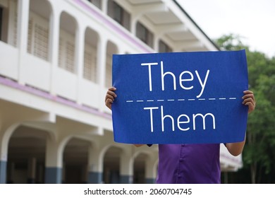 Concept : English grammar, subject and object pronouns teaching. Words " They- Them" on paper sign held by a student at school. Word card for education. Teaching material. Personal pronouns.  - Shutterstock ID 2060704745