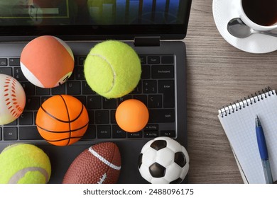 Concept of entertainment with technology in sports with laptop with an analysis application and game results on an office table with balls. Top view. - Powered by Shutterstock