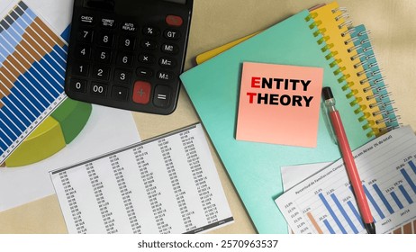 Concept of Entity Theory write on sticky notes isolated on Wooden Table.