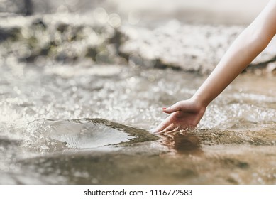 Concept Of Environment,Natural Touch,Hand Touches The Water In Nature,copy Space For Text