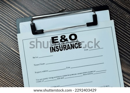Concept of EO - Errors and Omissions Insurance write on document isolated on Wooden Table.
