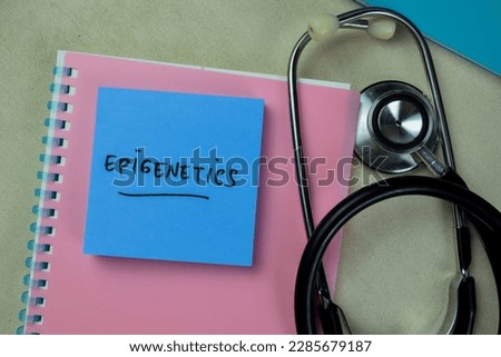 Concept of Epigenetics write on sticky notes with stethoscope isolated on Wooden Table.
