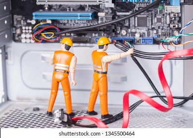 The concept of error correction or repair your computer. Miniature toy engineers fixing error on motherboard. Close-up view.  - Powered by Shutterstock