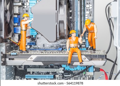 The concept of error correction or repair your computer. Miniature toy engineers fixing error on motherboard. Close-up view. - Powered by Shutterstock