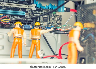 The concept of error correction or repair your computer. Miniature toy engineers fixing error on motherboard. Close-up view. - Powered by Shutterstock