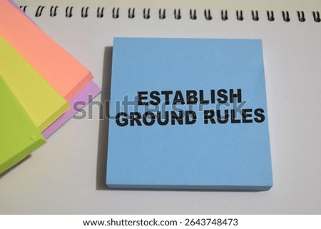 Concept of Establish ground rules write on sticky notes isolated on Wooden Table.