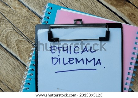 Concept of Ethical Dilemma write on paperwork isolated on Wooden Table.