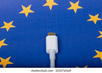 Concept For EU Law To Force USB-C Chargers For All Phones. EUROPEAN UNION Flag And USBC Universal Charging Cable As A Standard For Small Electronic Devices