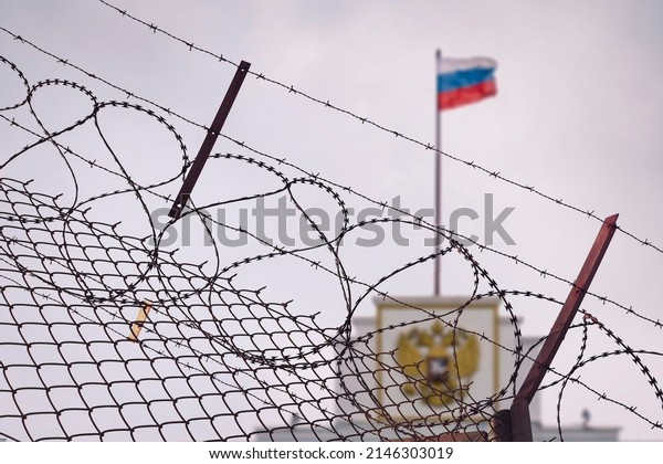 The concept of European and US sanctions pressure\
on the Russian Federation government. flag of the Russian\
Federation in barbed wire, sanctions and aggression of Russia.\
Russian prison