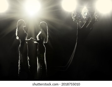 Concept every Girls Dream to be Miss beauty pageant queen Universe contest. Women warships raise Diamond Silver Crown as Final winner on stage, studio lighting with backlit light flare silhouette