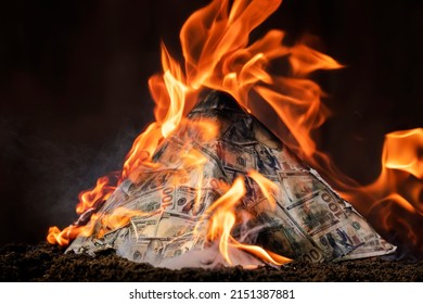The concept of exchange in financial markets is the collapse of the financial system of capitalism. collapse of a financial pyramid, dollars are burning in the dark. - Shutterstock ID 2151387881