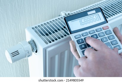 Concept Of Expensive Heating Costs. Hands With Calculator Consider Cost Of Heating. Saving Energy In Times Of Crisis Caused By High Cost Of Energy. Savings On Heating