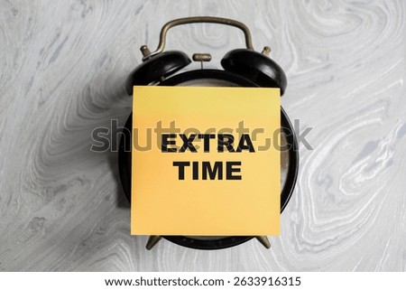 Concept of Extra time write on sticky notes isolated on Wooden Table.