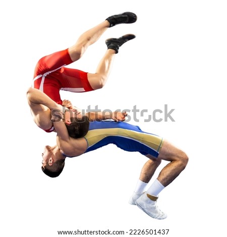 The concept of fair wrestling. Two greco-roman  wrestlers in red and blue uniform wrestling   on a white background.The concept of fair wrestling