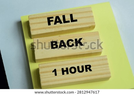 Concept of fall back 1 hour text on wooden blocks.